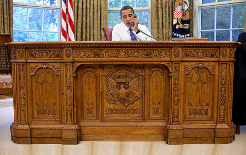 http://commons.wikimedia.org/wiki/File:Barack_Obama_sitting_at_the_Resolute_desk_2009.jpg