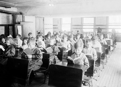 http://commons.wikimedia.org/wiki/File:Schoolchildren_reading_1911.jpg
