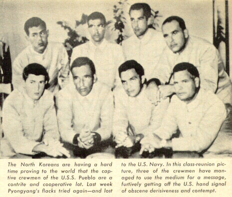 https://en.wikipedia.org/wiki/File:North_Korea_Propaganda_Photograph_of_prisoners_of_the_USS_Pueblo,_with_the_Hawaiian_Good_Luck_Sign,_1968.jpg