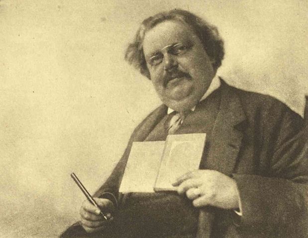 https://commons.wikimedia.org/wiki/File:Chesterton_Holding_Book_and_Pen.jpg